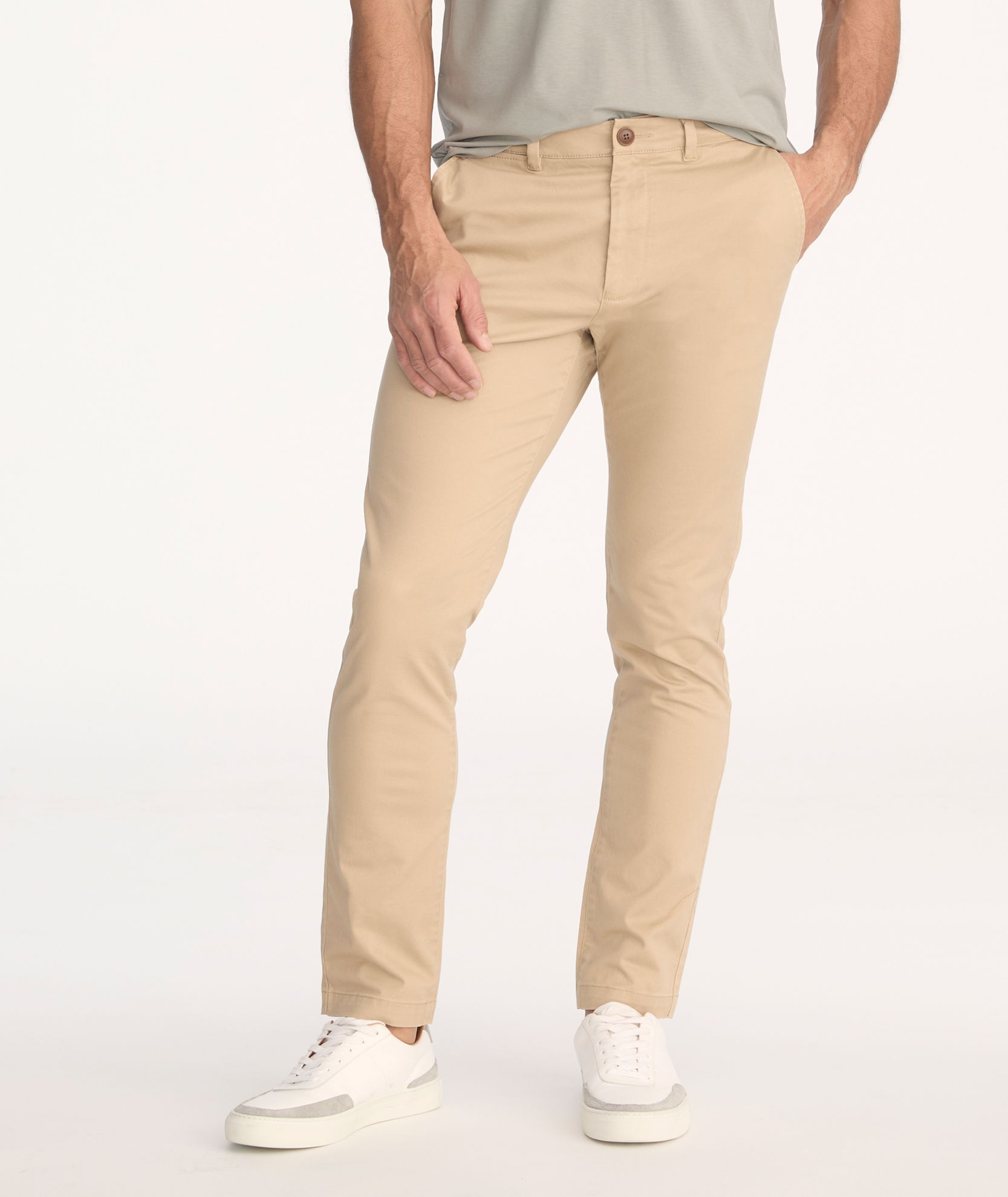 A person wearing beige pants and white sneakers.