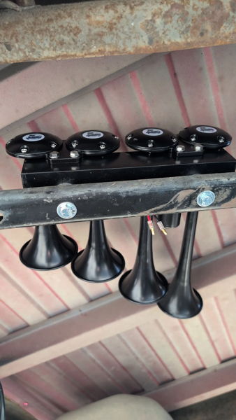 Four black 4CHIME air horns mounted on bracket under Kevin's Silverado truck bed photo 2