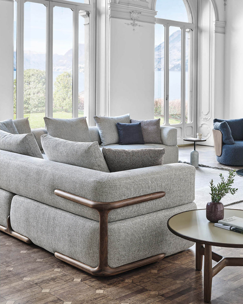 Modern Porada living room with gray klem sofa and a circular coffee table.