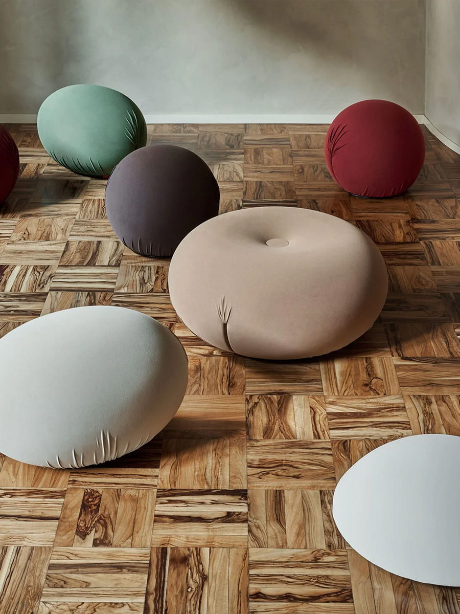 Colorful cushioned Baleri Italia seating on a wooden floor.
