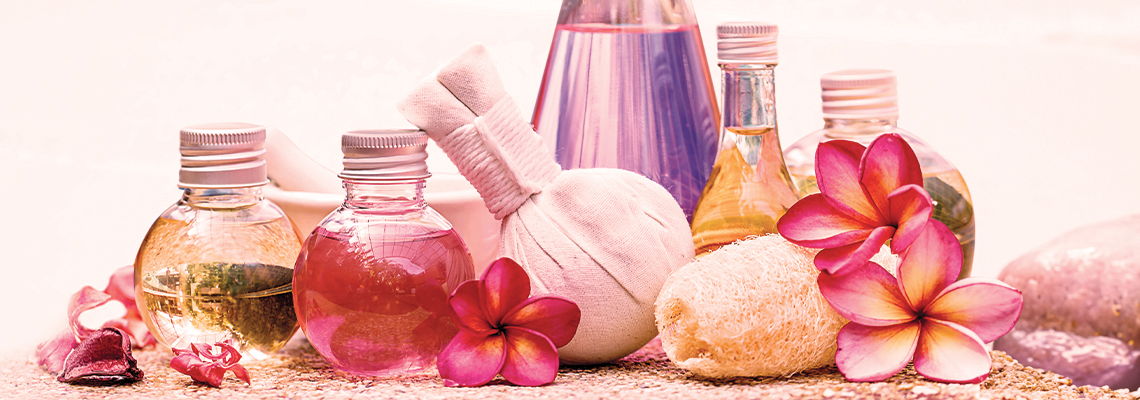 Collection of beauty products and flowers on a soft background.