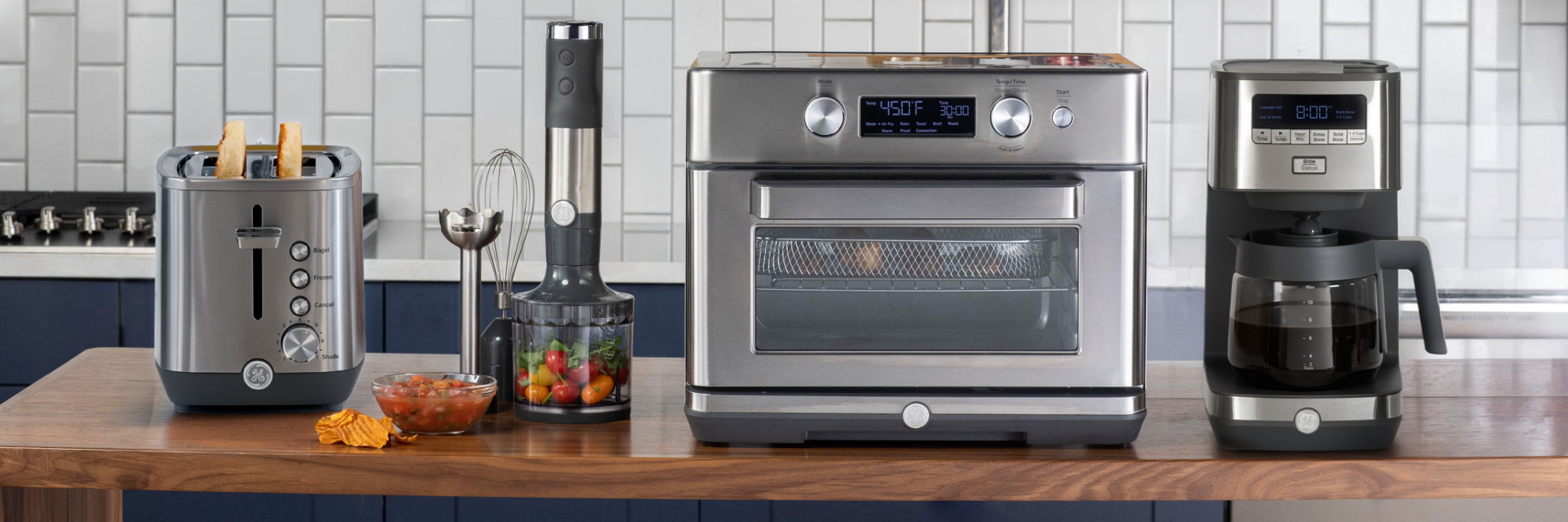 Kitchen appliances including toaster, oven, and coffee maker on a wooden countertop.