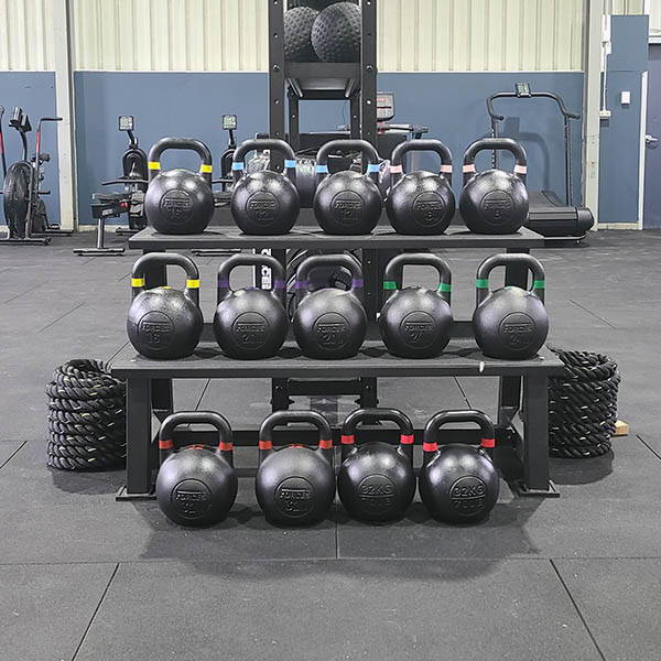 High School Gym Fit Out with a neatly organized rack of kettlebells, catering to a variety of strength and conditioning routines.