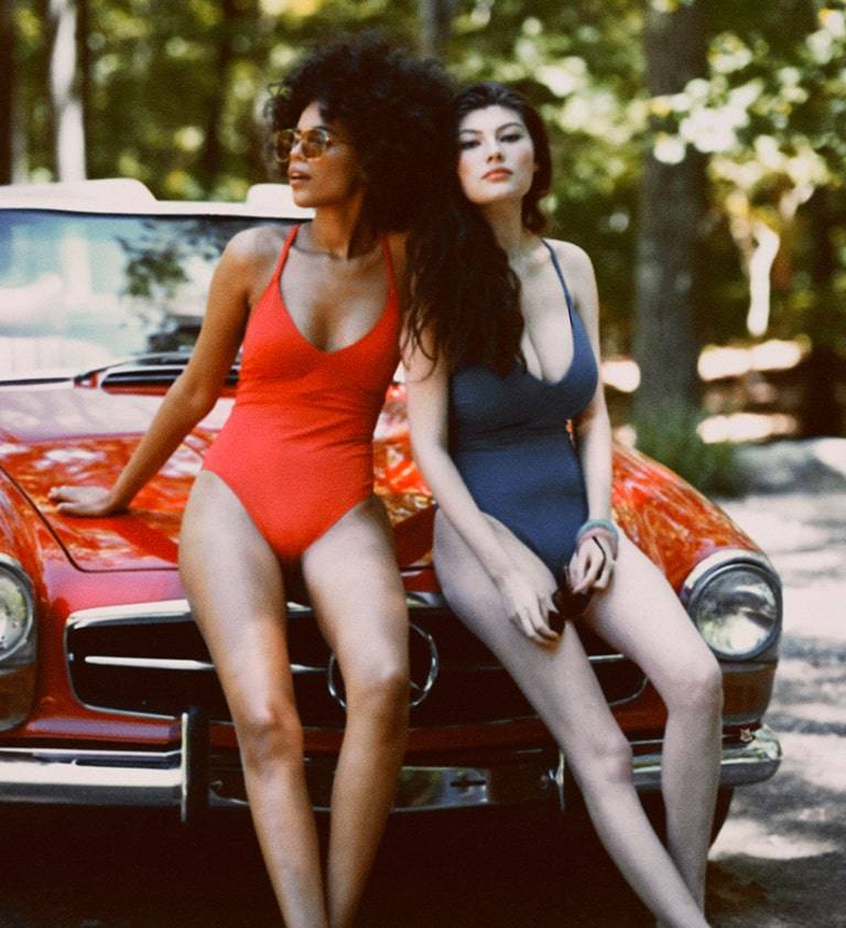 Two models wearing cosabella one piece swimsuits.