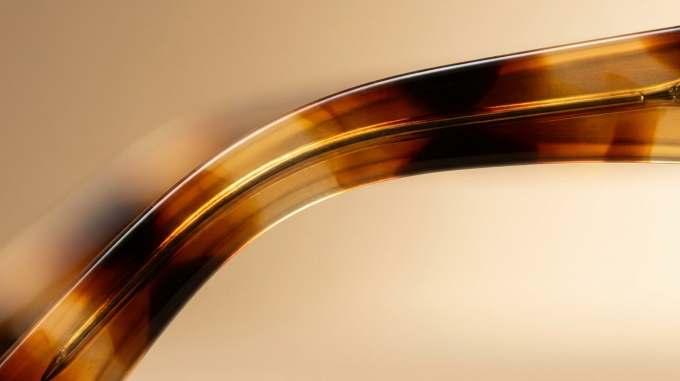 Close-up of tortoiseshell acetate frame showing marbled brown and amber pattern