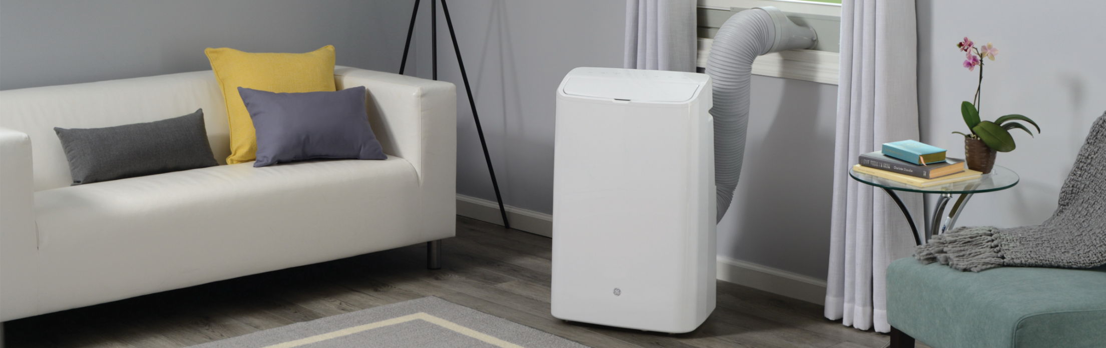 Air conditioner in a living room with sofa and side table.