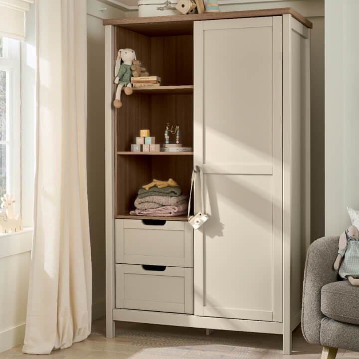 A light-colored wardrobe with shelves and drawers in a bright room.