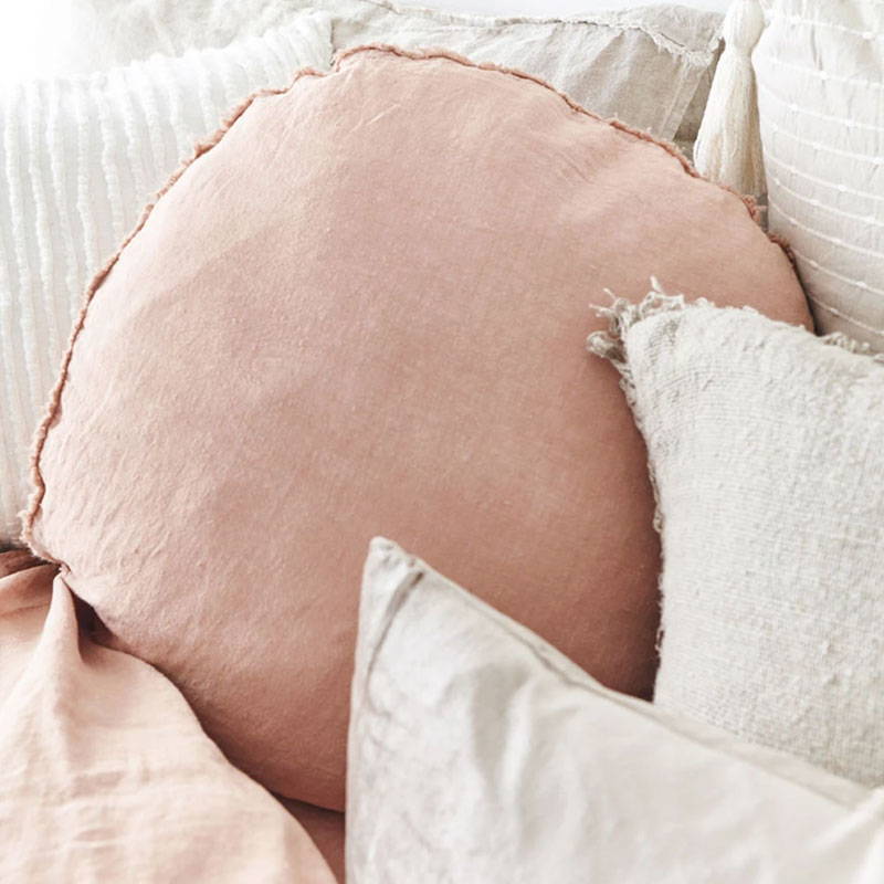 Pink Lulu Linen Cushions paired with velvet  cushions  on bed