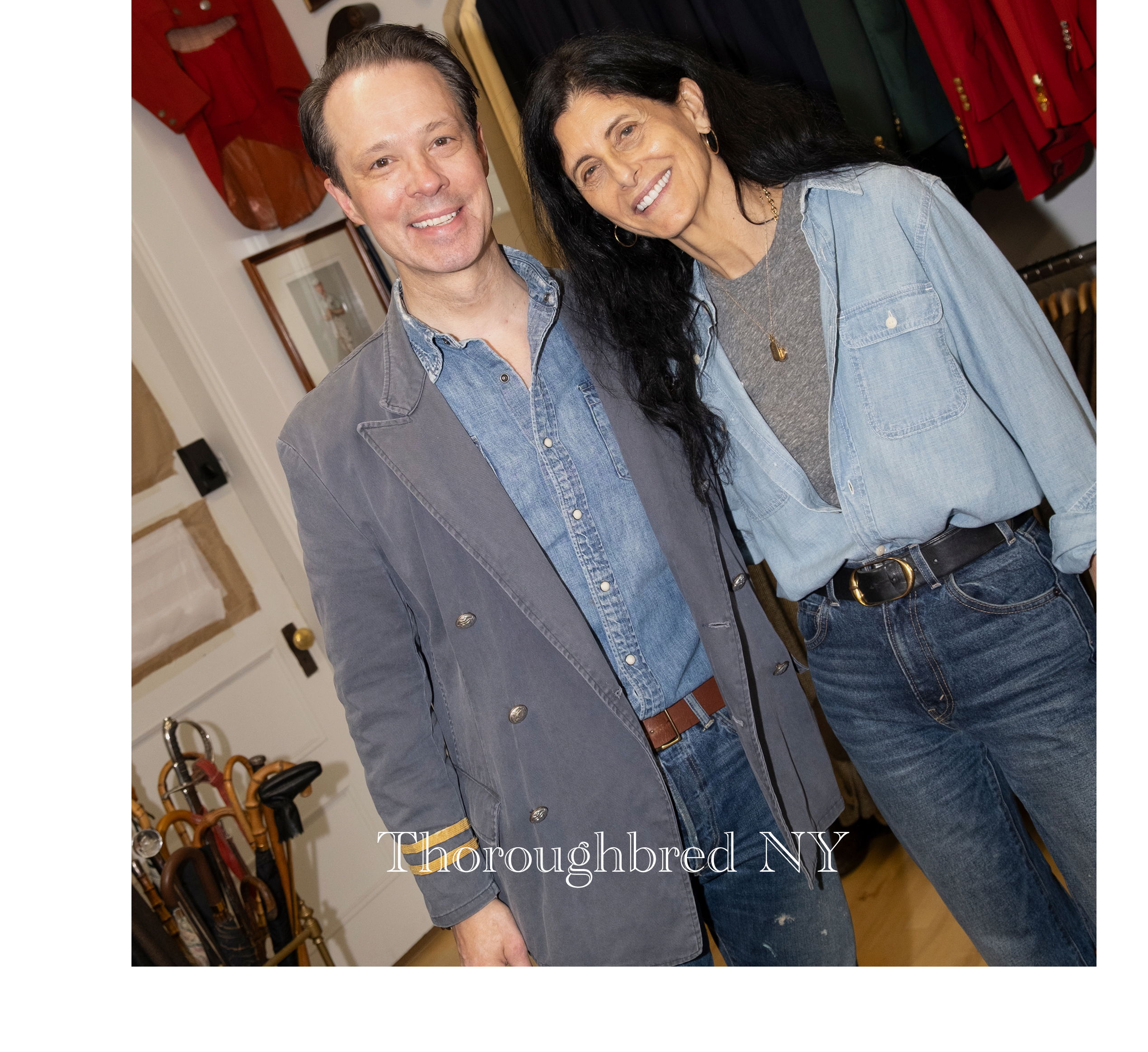 Two smiling individuals posing together in a cozy indoor setting.