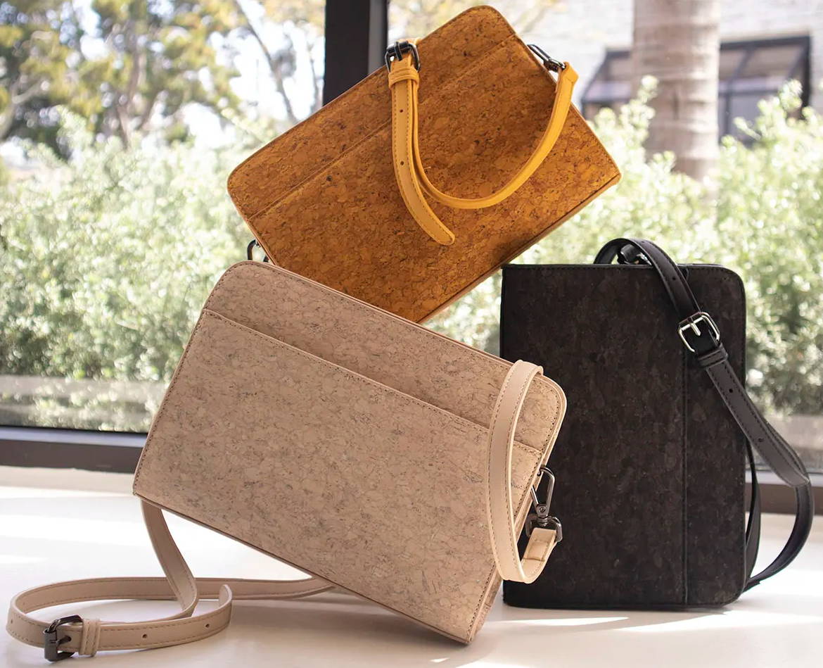 three cork handbags by Evolution Smart Bagstacked onto one another
