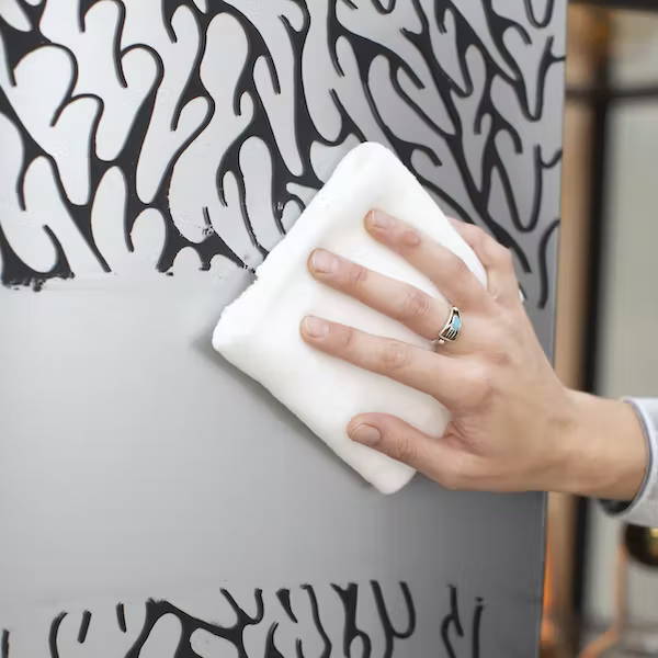 Wiping drawing off of Modern Glass refrigerator