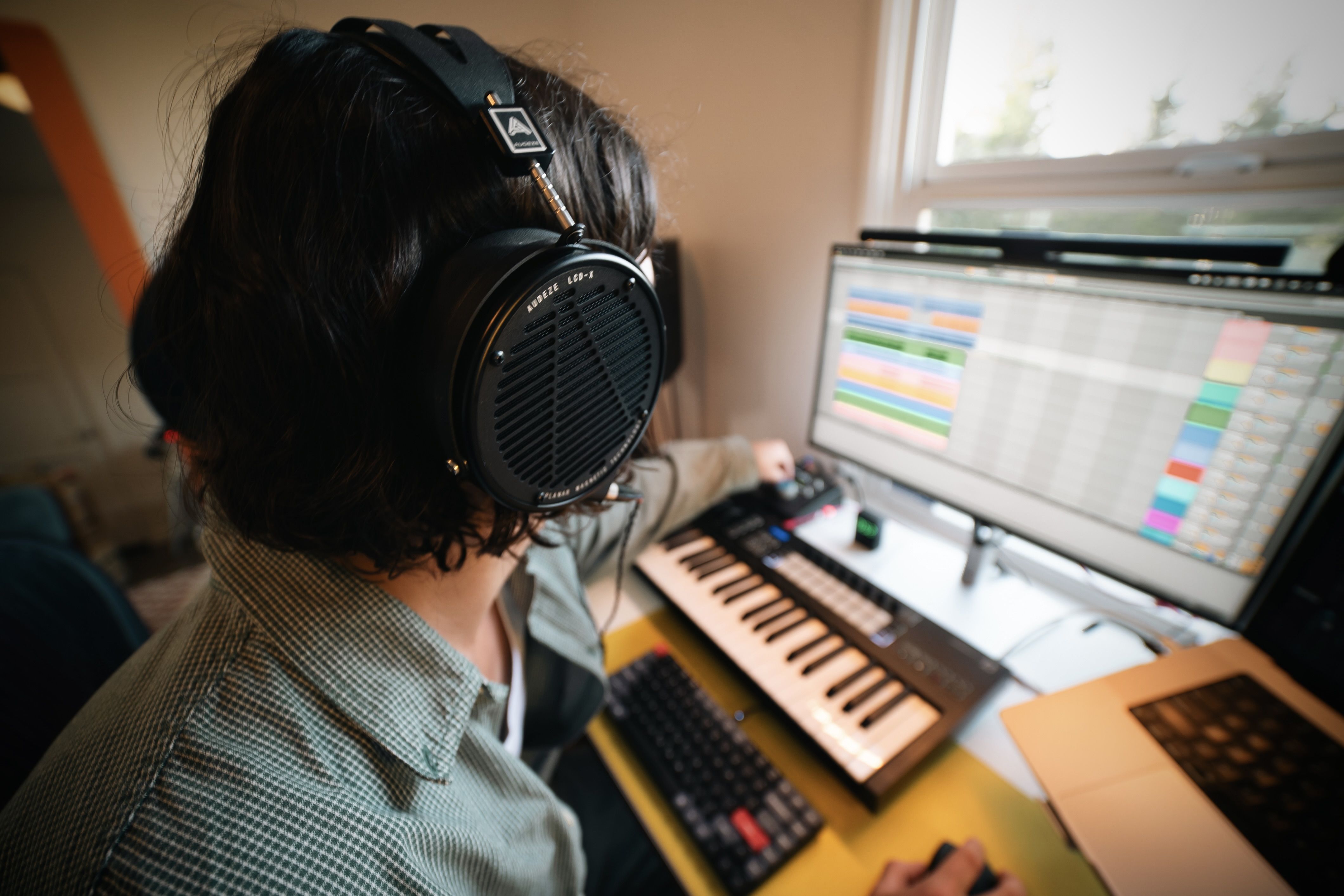 BAYNK wearing Audeze LCD-X headphones In the studio 