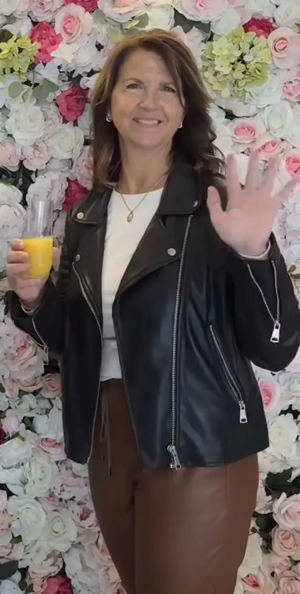 Nina smiling, holding mimosa 