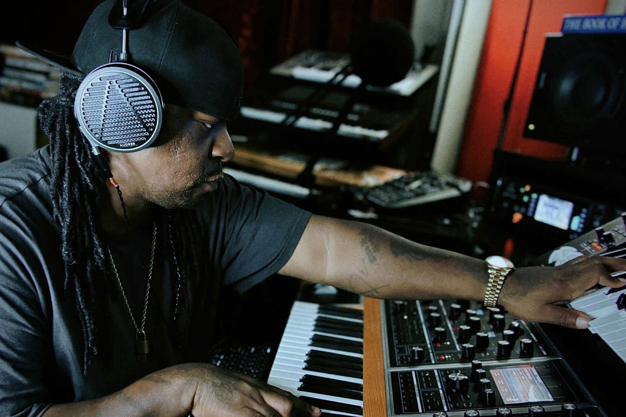 Snipe Young wearing Audeze MM-500 headphones while mixing 