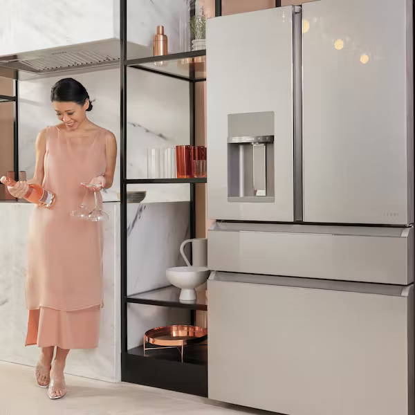 Woman with bottle of wine next to Café Quad door refrigerator