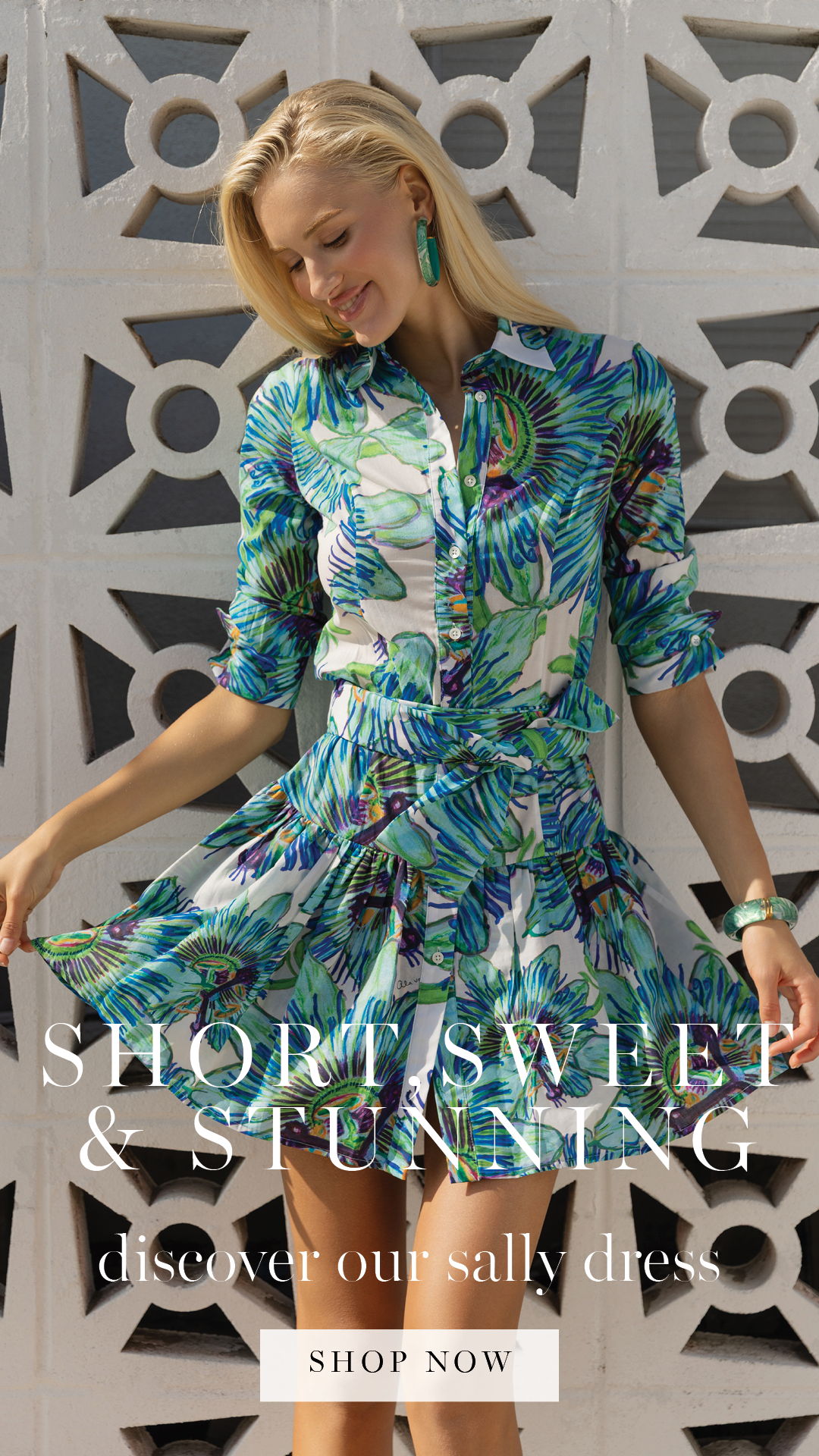 Model in floral dress against a textured background, promoting a clothing line.