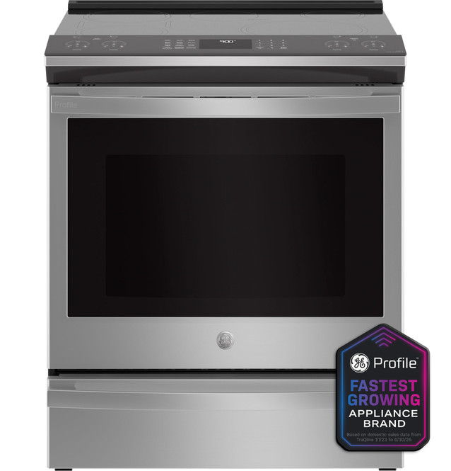 A modern stainless steel kitchen range with a black oven door.