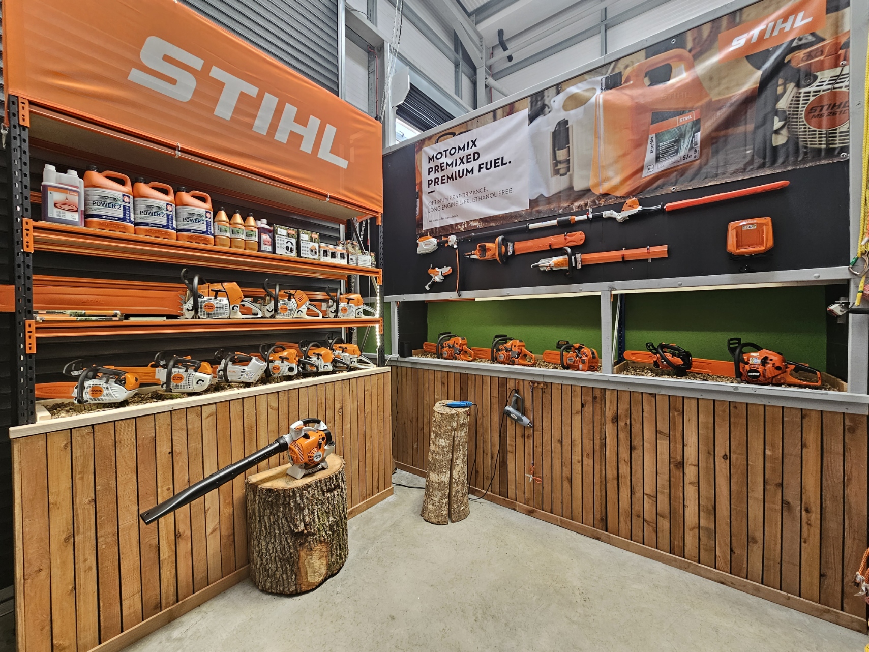 STIHL display featuring chainsaws and products in a retail setting.