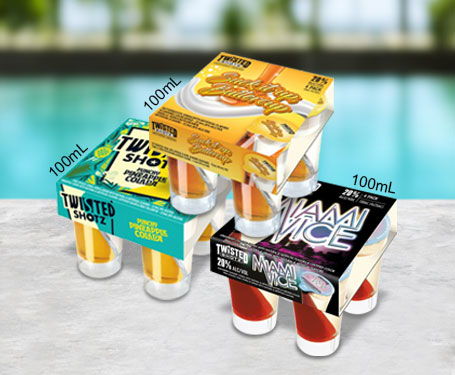Four packs of flavored shots on a stone surface near a pool.