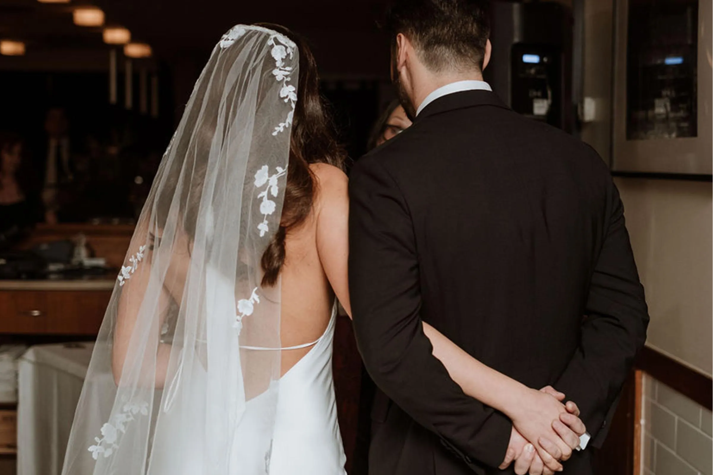 Bride and groom holding hands