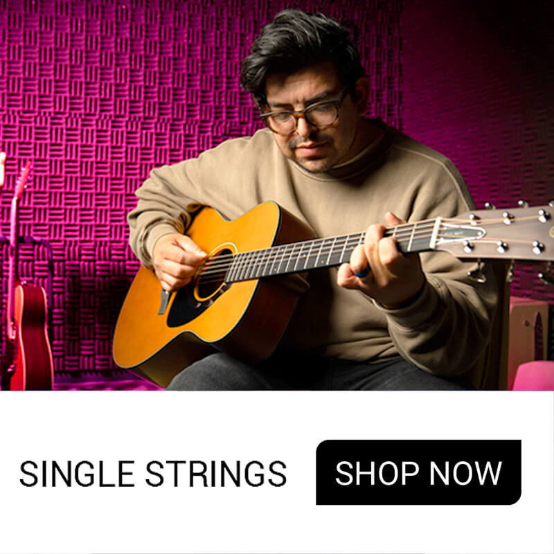 Person playing an acoustic guitar with a colorful background.