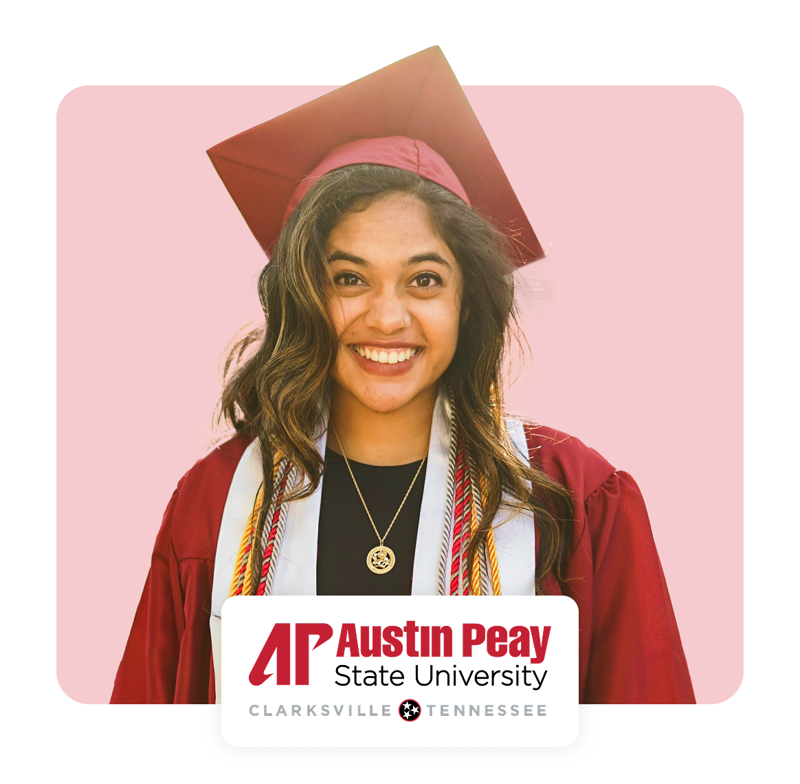 Smiling graduate in cap and gown with university logo.