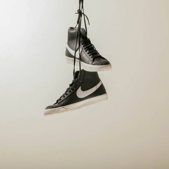 black nike blazers hanging by laces