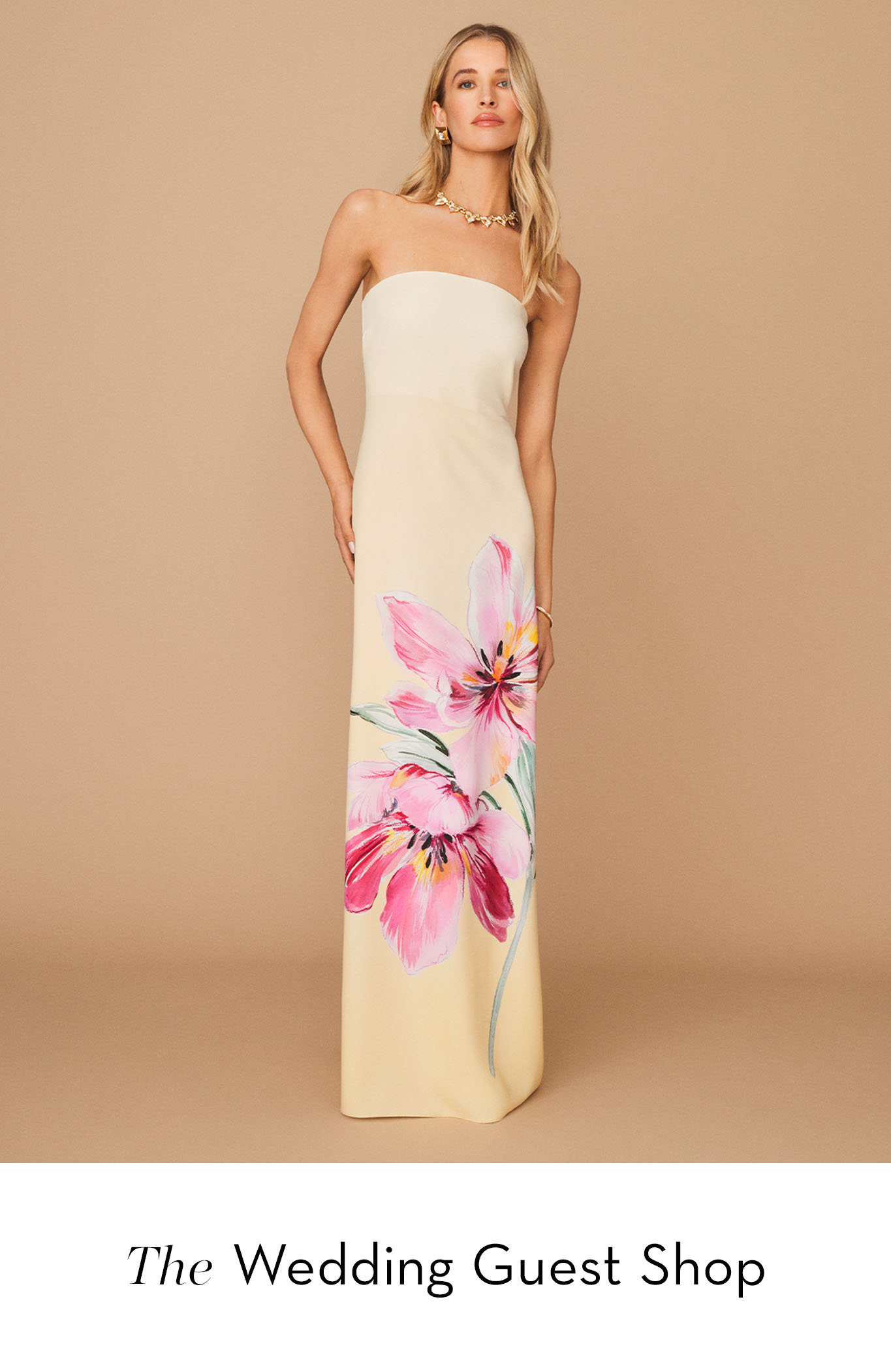 Model wearing a strapless floral dress against a neutral background.