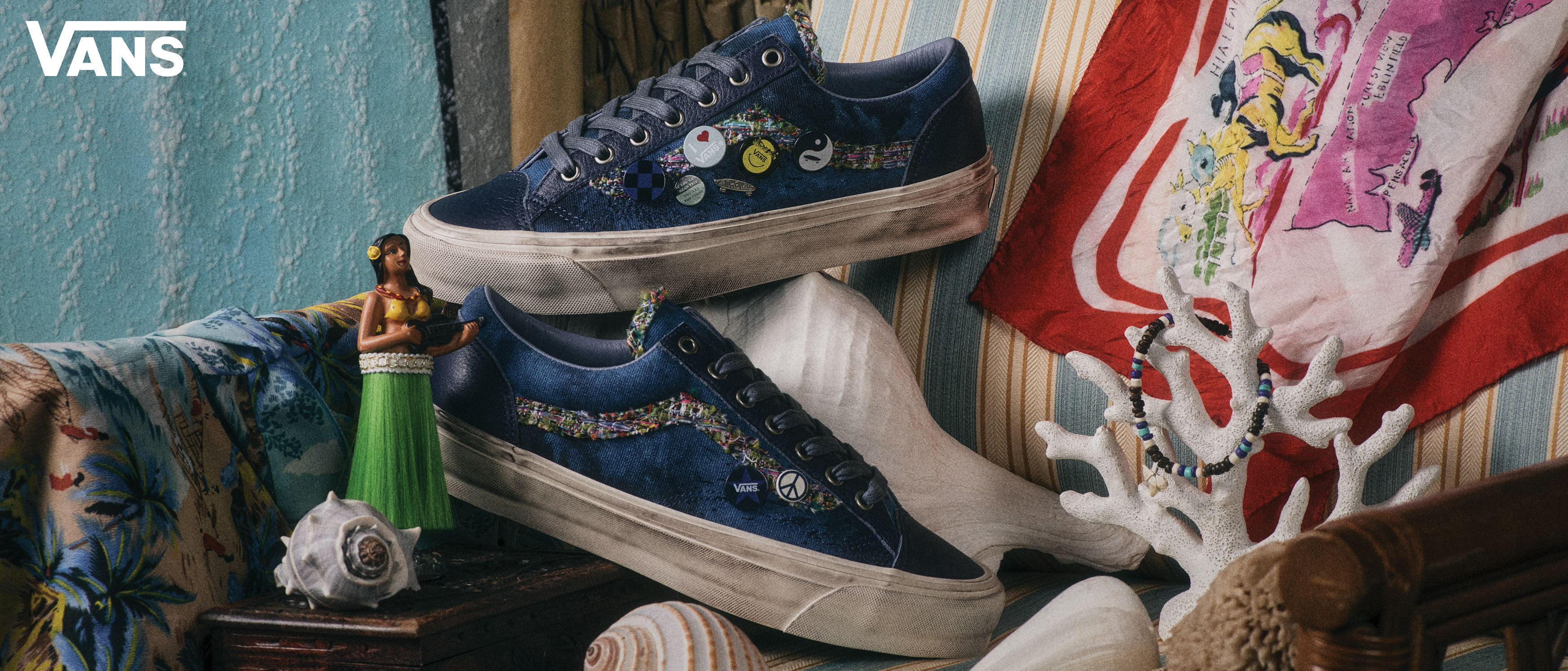 Blue Vans shoes displayed on a colorful background with various items.
