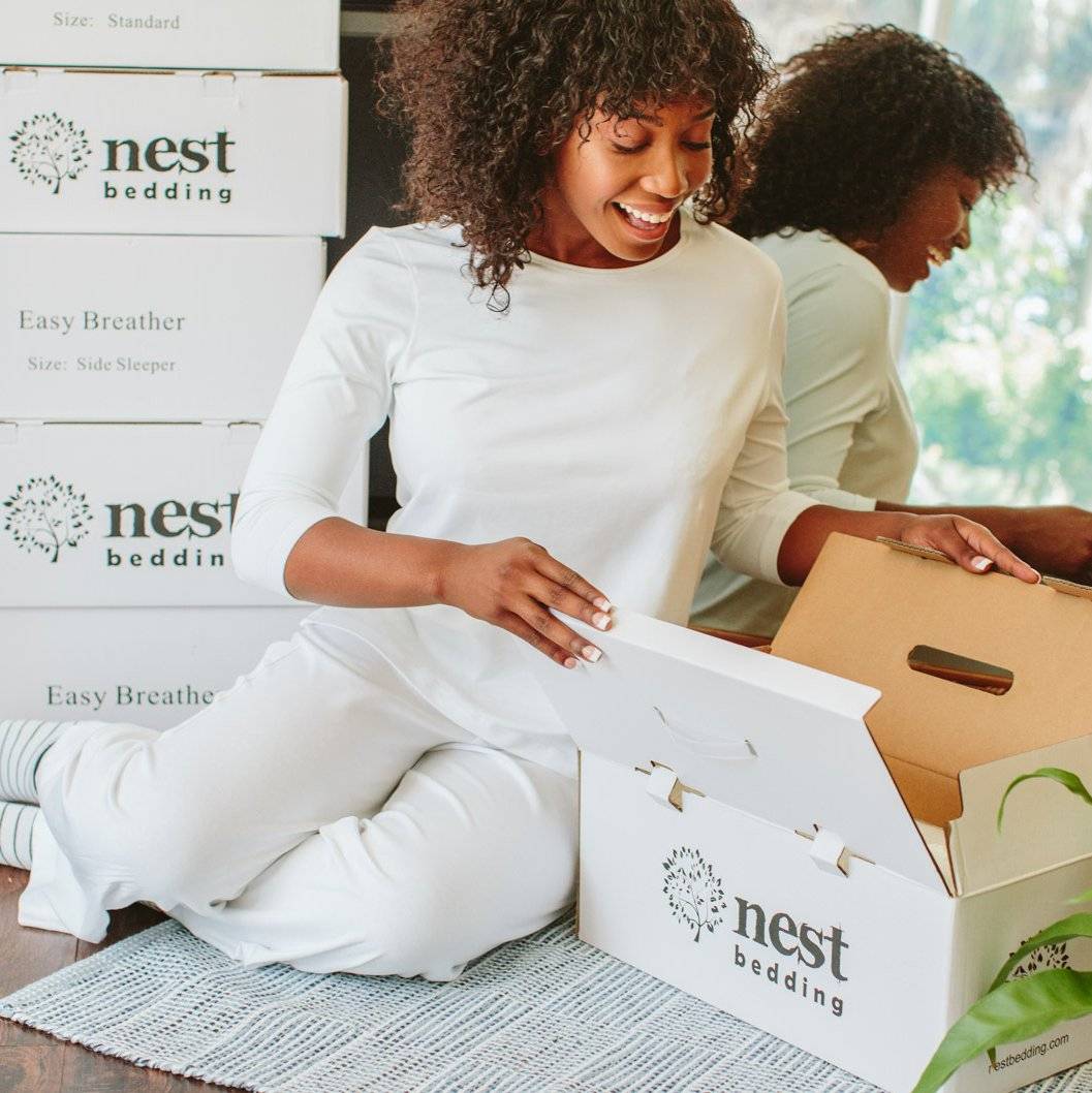 woman opening nest bedding package 