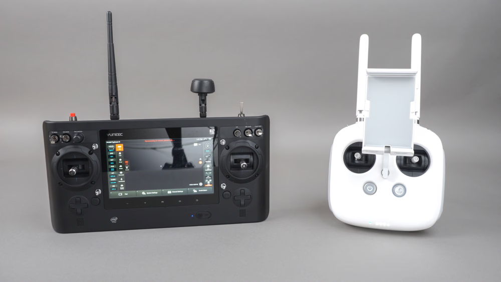 The Typhoon H and Phantom 4 remote controllers side-by-side on a gray background.