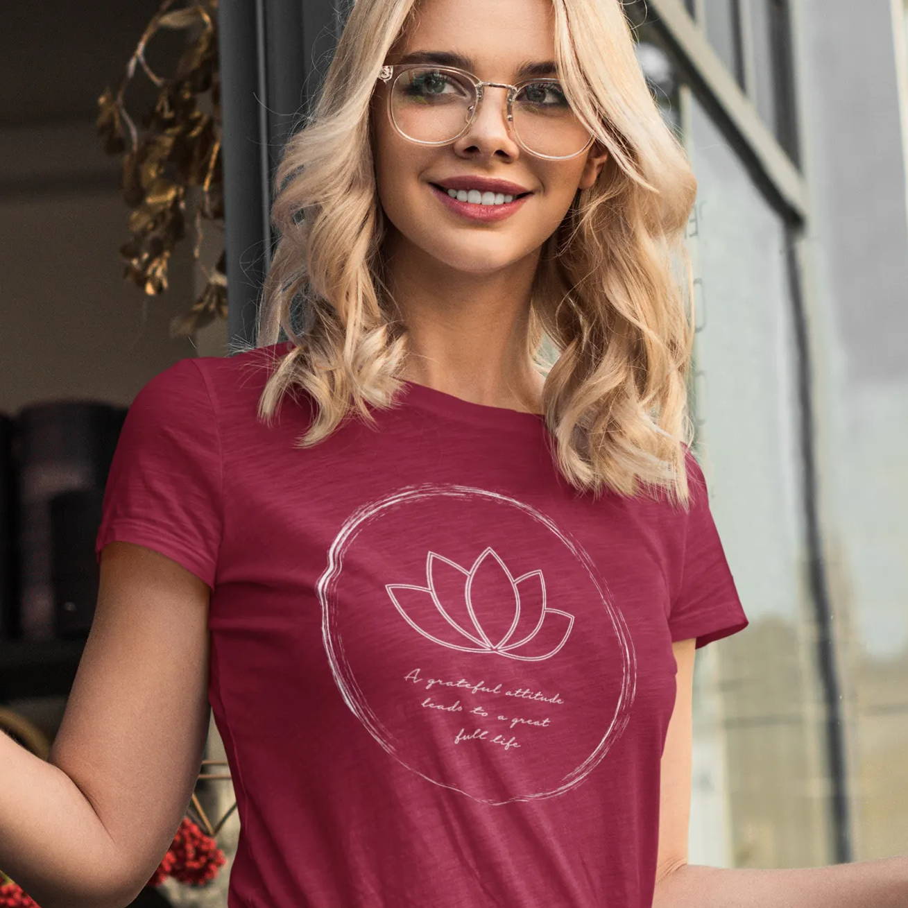 A woman wearing a red shirt with a lotus flower design