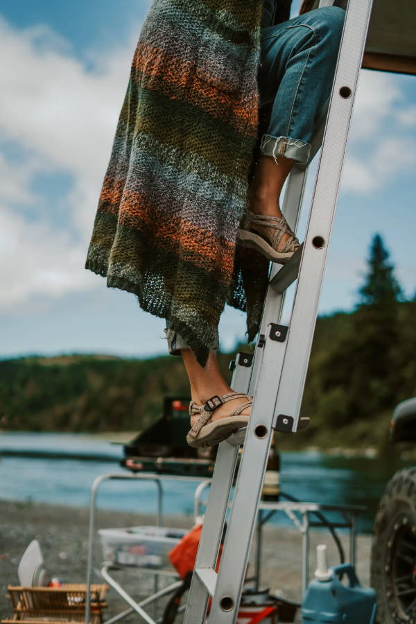 woman climbing a ladder with water sandals