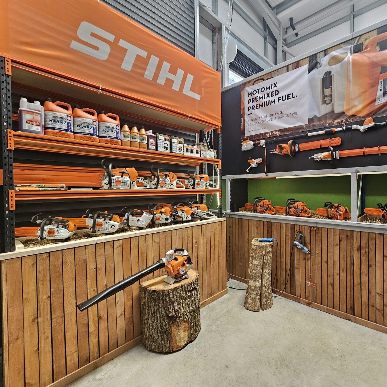 STIHL display featuring chainsaws, tools, and accessories in a store setting.