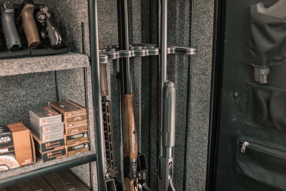 A gun safe with firearms and ammunition stored inside.
