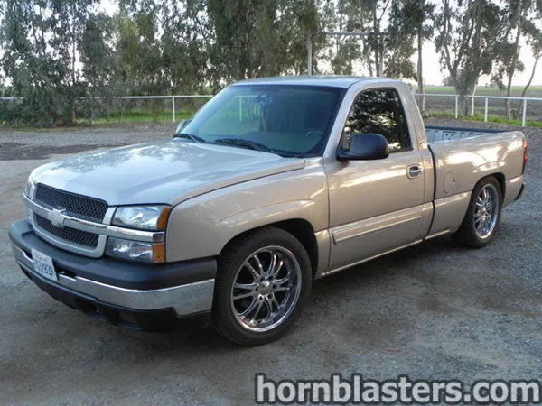Front three-quarter view of Thomas's silver 2005 Chevrolet Silverado 1500 parked on gravel, install photo 2