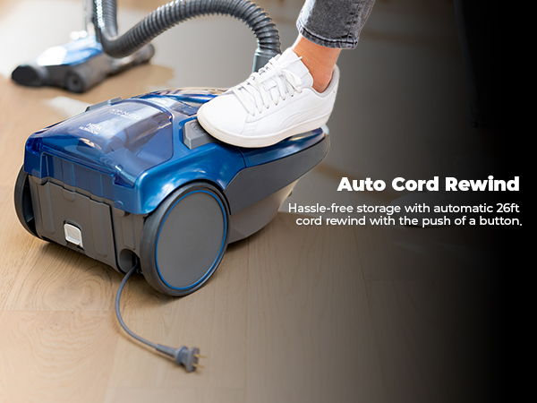 Vacuum cleaner with auto cord rewind feature being operated by foot.