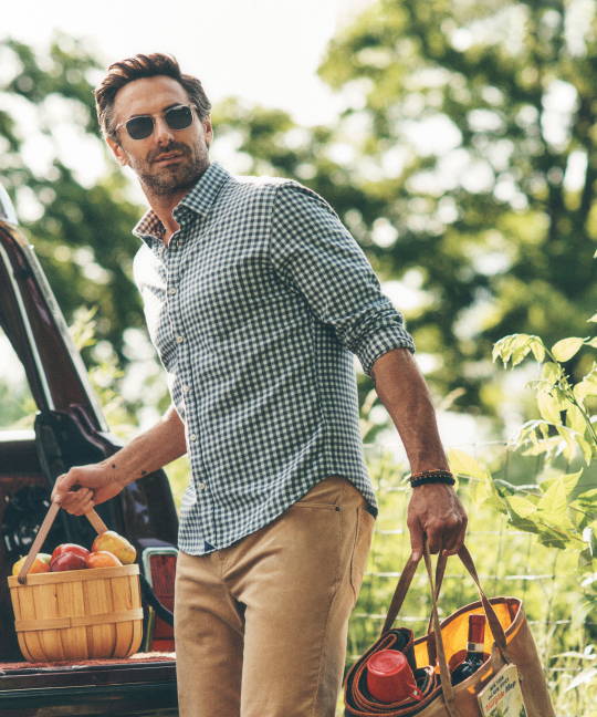 Model is wearing the UNTUCKit Alden flannel with the Christow pants in tan. 