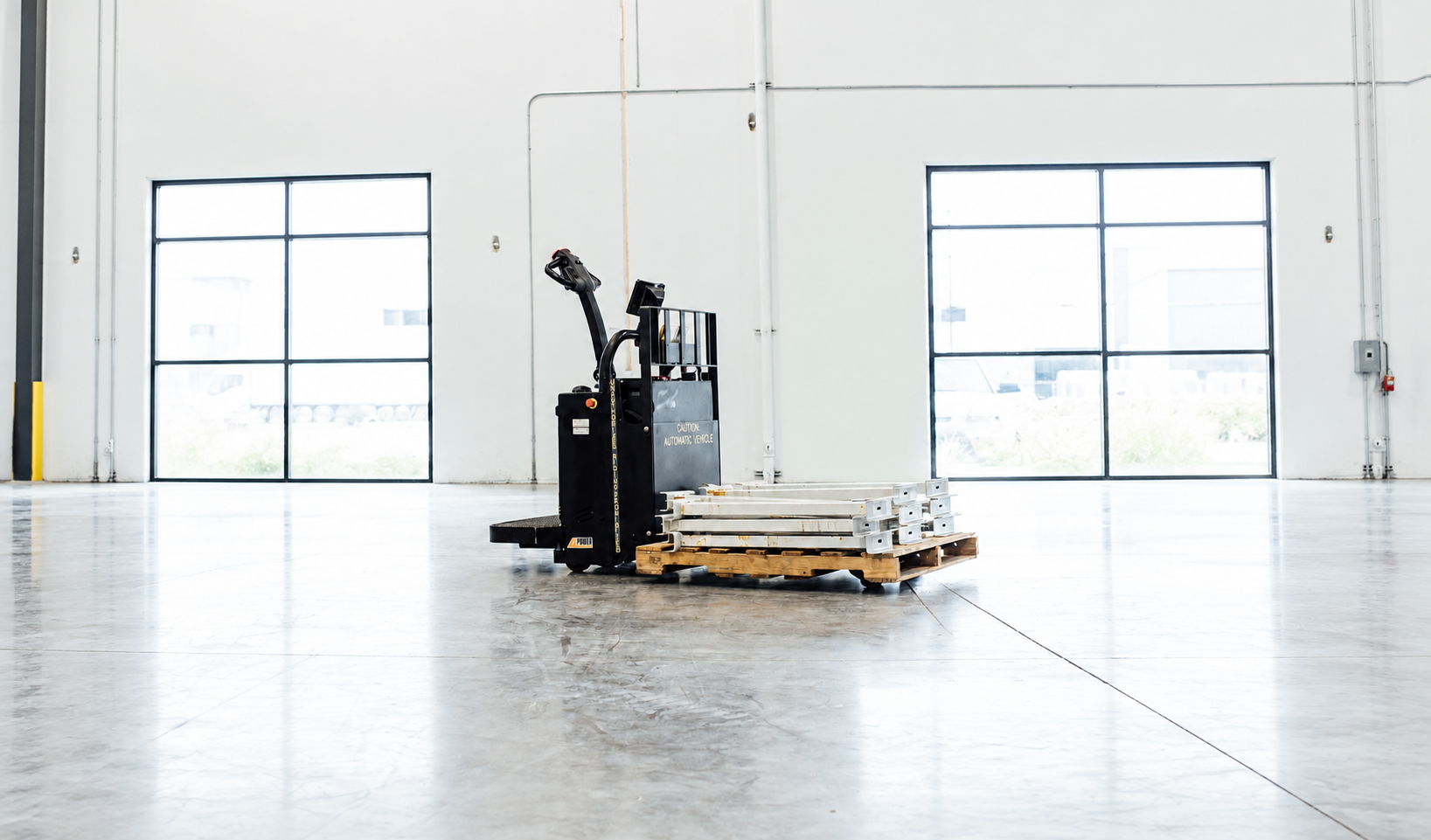 AGV moving autonomously through a warehouse with a small load