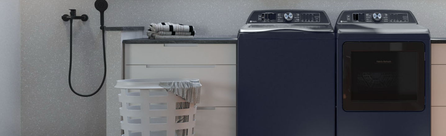 Laundry room with washing machine, dryer, and stacked laundry baskets.