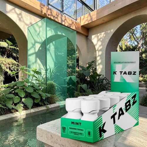 A display of K TABZ products in a lush indoor setting.