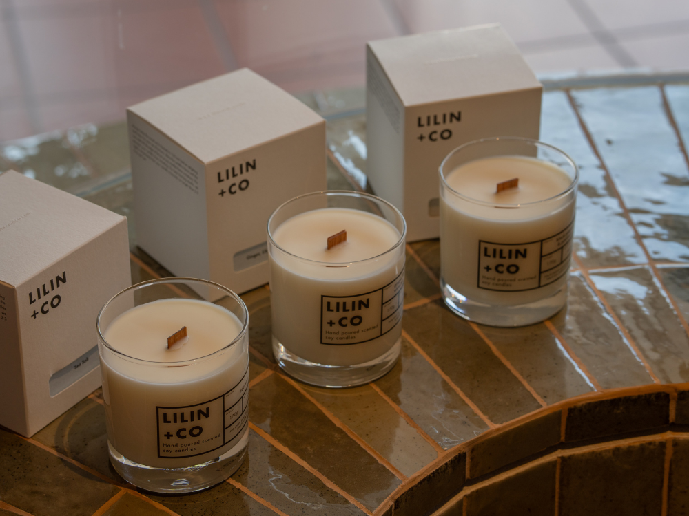 three candles on a tiled shelf