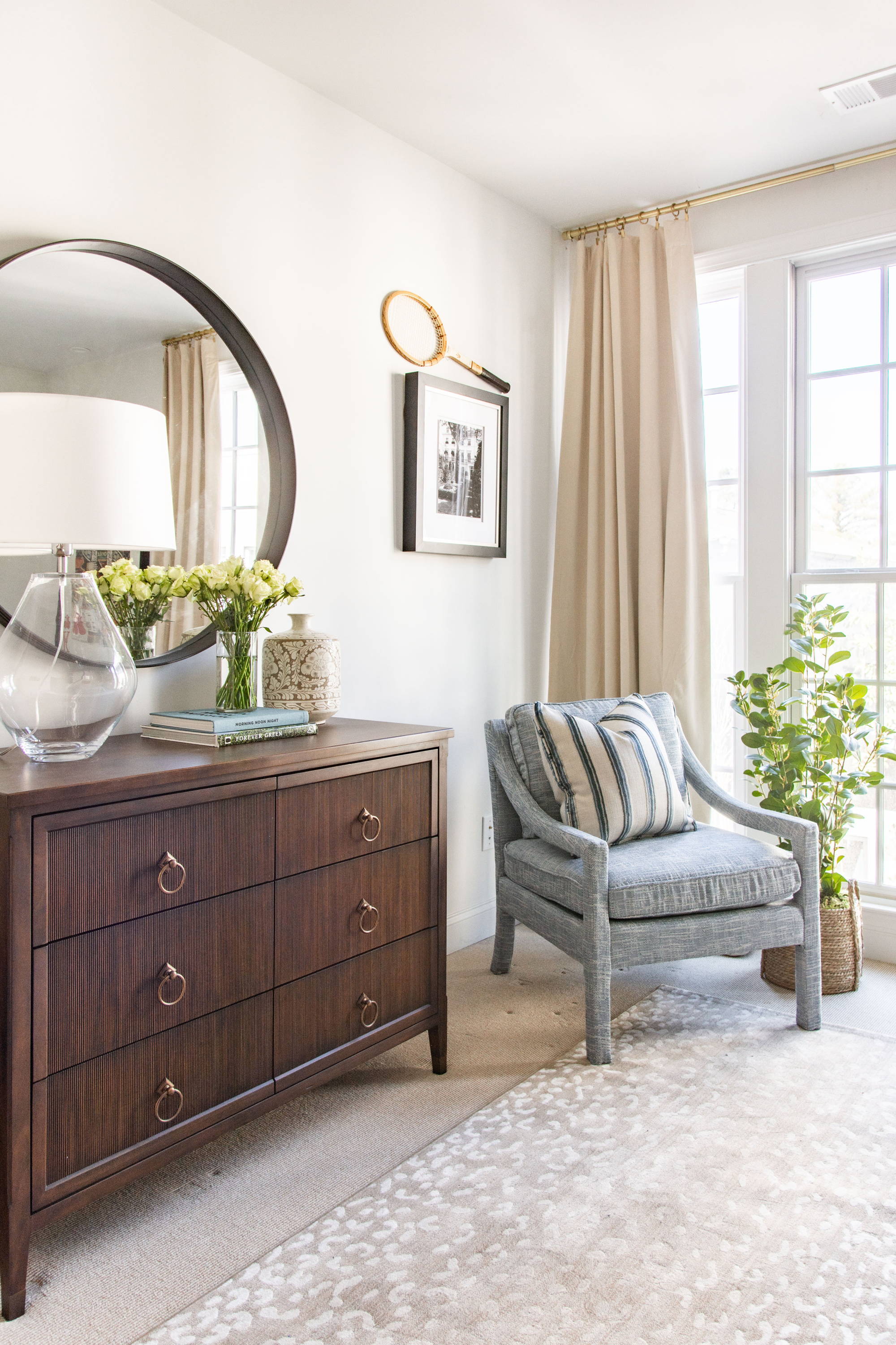 A classic primary bedroom design in Atlanta, GA by interior designer Kevin Francis O'Gara, featuring Frontgate fluted dresser, french nightstands, blue Parsons armchairs, and antelope spotted rug #bedroom #bedroomdesign #interiordesign