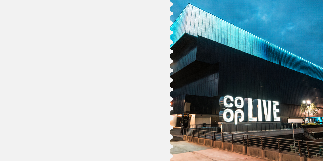 Co-op Live venue with illuminated sign against a night sky.