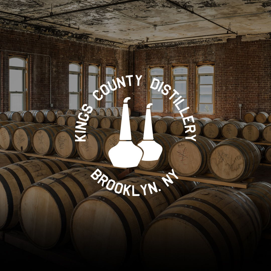 Interior of Kings County Distillery distillery with barrels and logo.