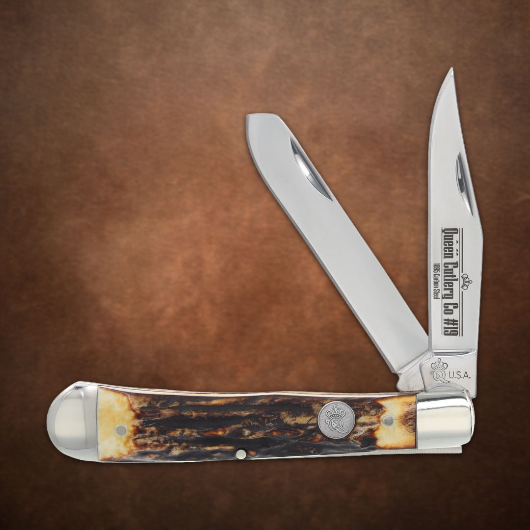 A folding knife with two blades and a textured handle.