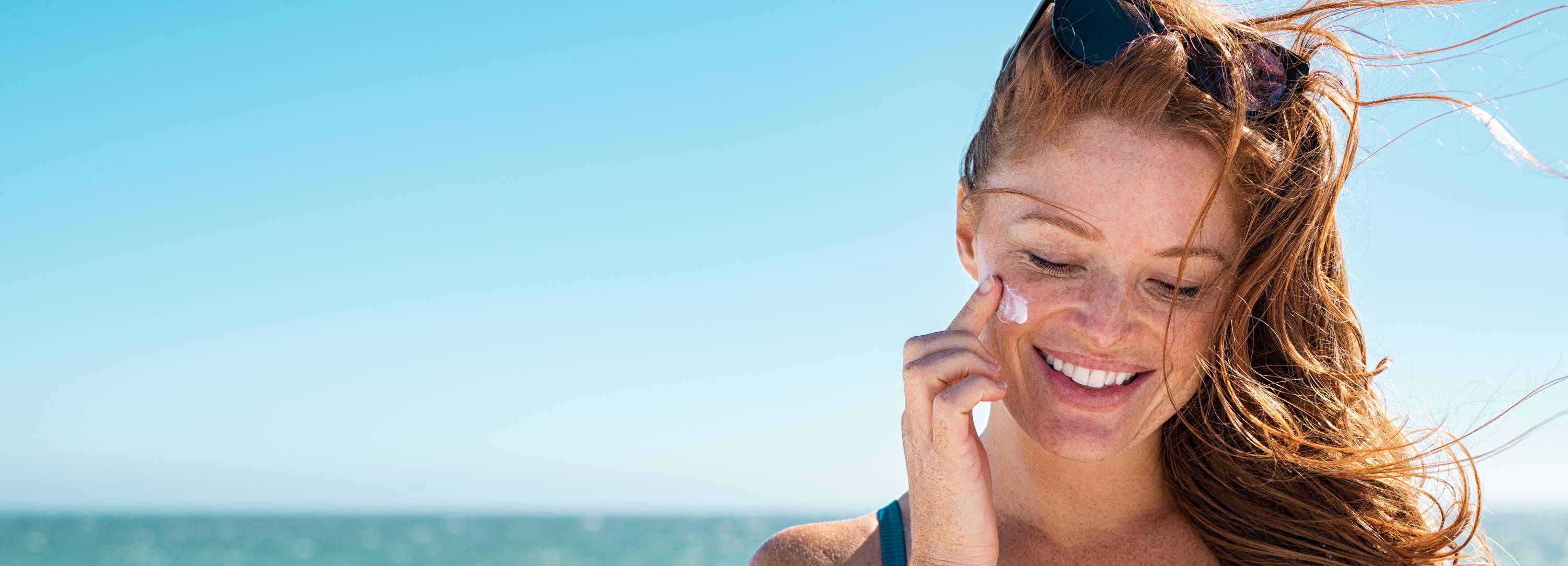 Woman applying sunscreen