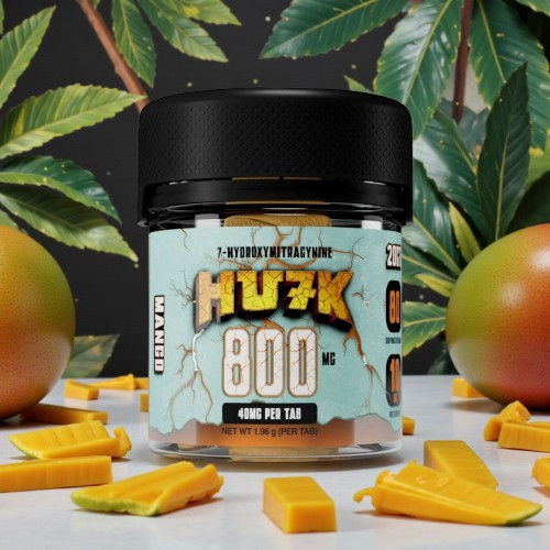 Container of HUFK 800 cannabis product with mango pieces and leaves.