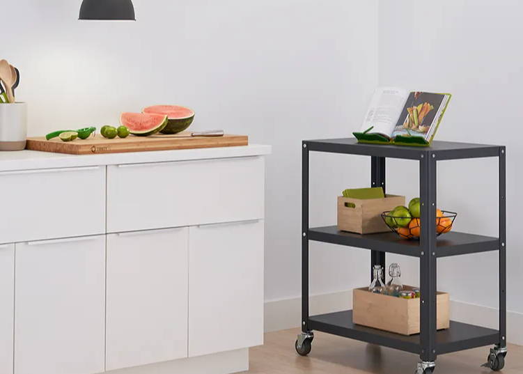 Kitchen cart with items on its shelves and bamboo cutting board removed