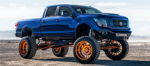Front three-quarter blue lifted 2017 Nissan Titan copper wheels FOX shocks desert CaliCustomsOKC Conductor's Special 544K Nightmare Edition train horn kit featured customer install gallery photo 1